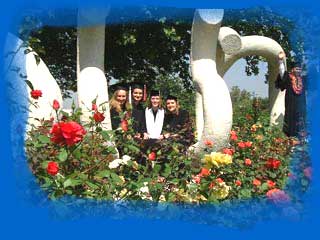 The fab four standing behind the CSUN Sculpture